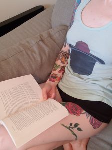 Amanja reading with a book in her lap