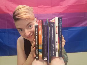 Amanja with a stack of independent books